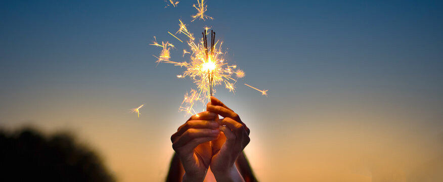 a woman holding sparklers